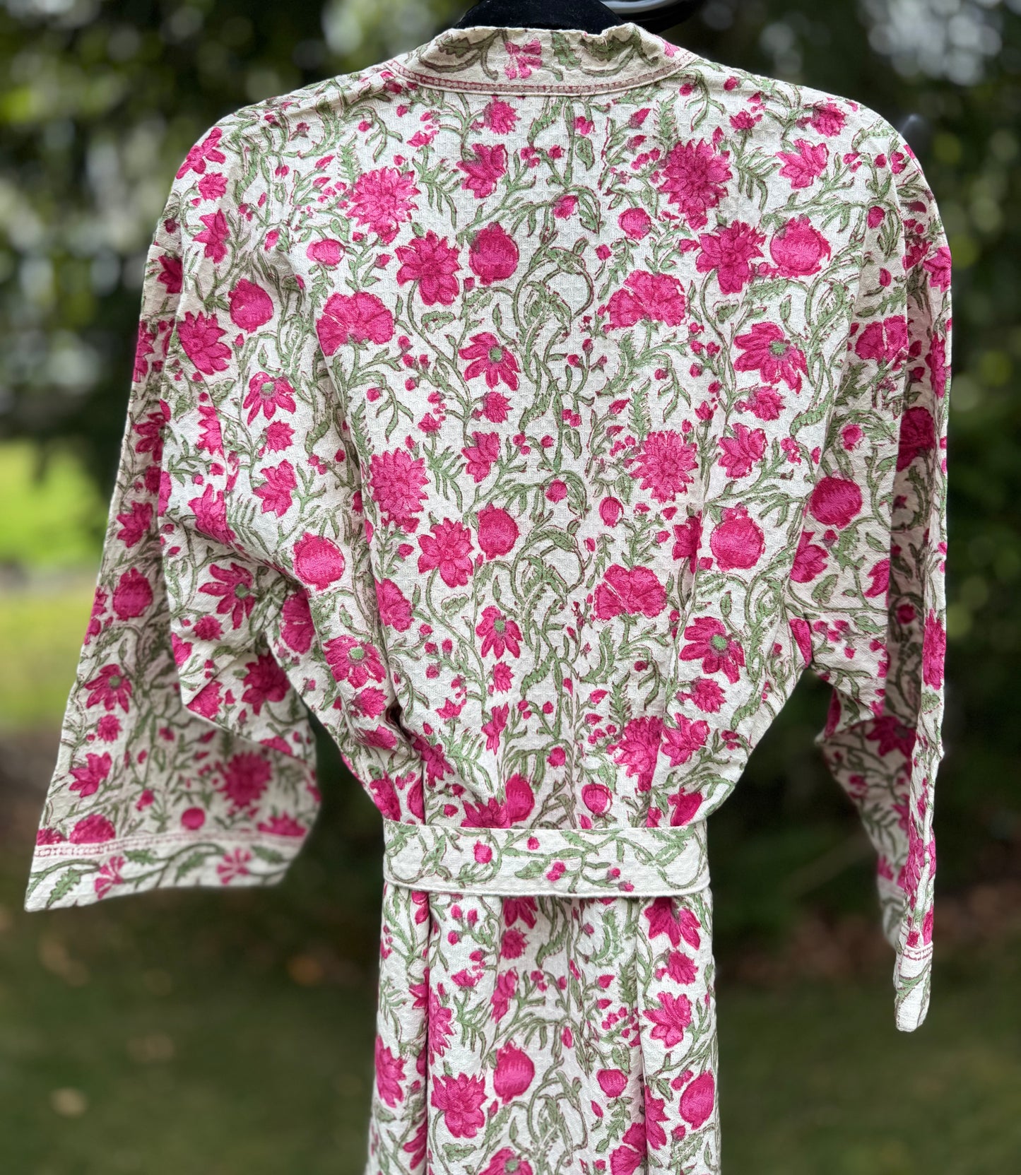 House of Mulmul - cotton bath robe. Floral patterned robe with pink flowers on a green background.