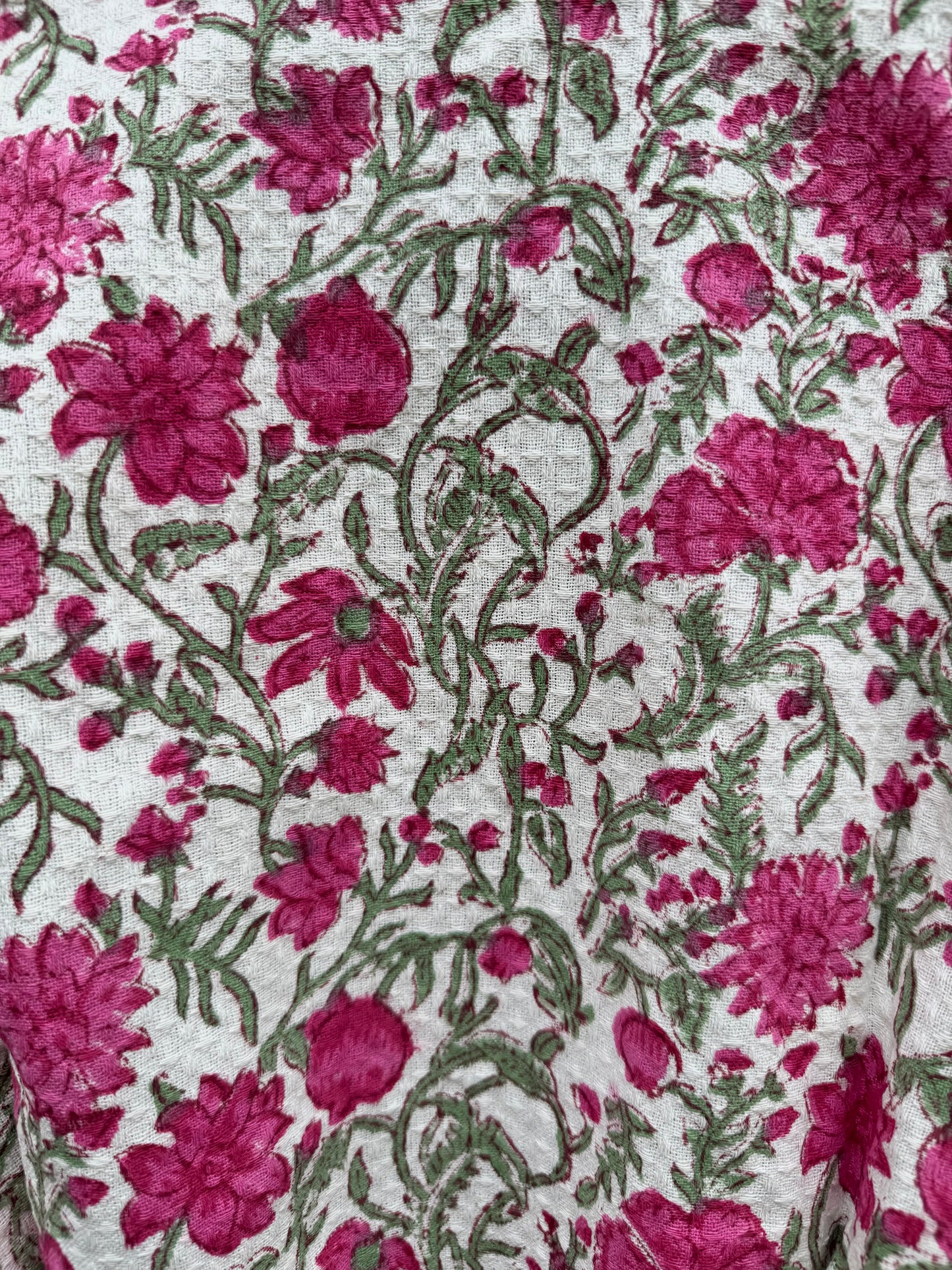 Floral pattern with pink flowers and green leaves on a white background