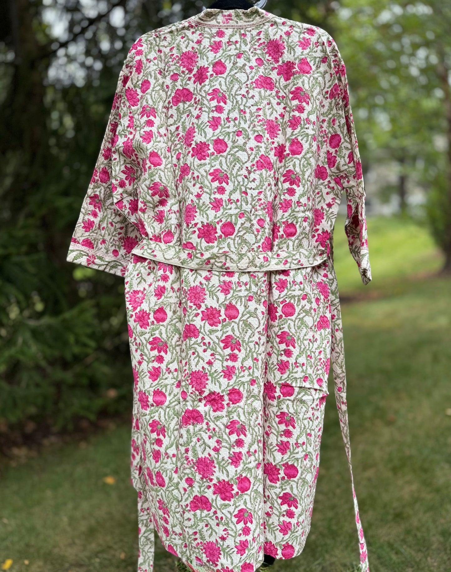 House of Mulmul - cotton bath robe. Floral patterned robe with pink flowers on a green background.