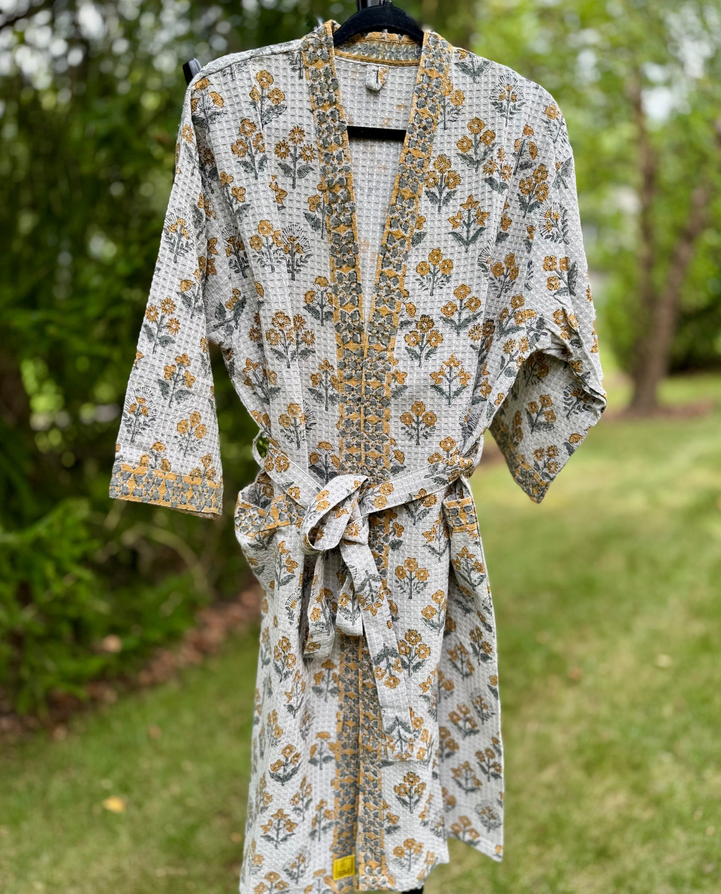 House of Mulmul - cotton bath robe. Floral gray patterned robe with yellow flowers on a green background.