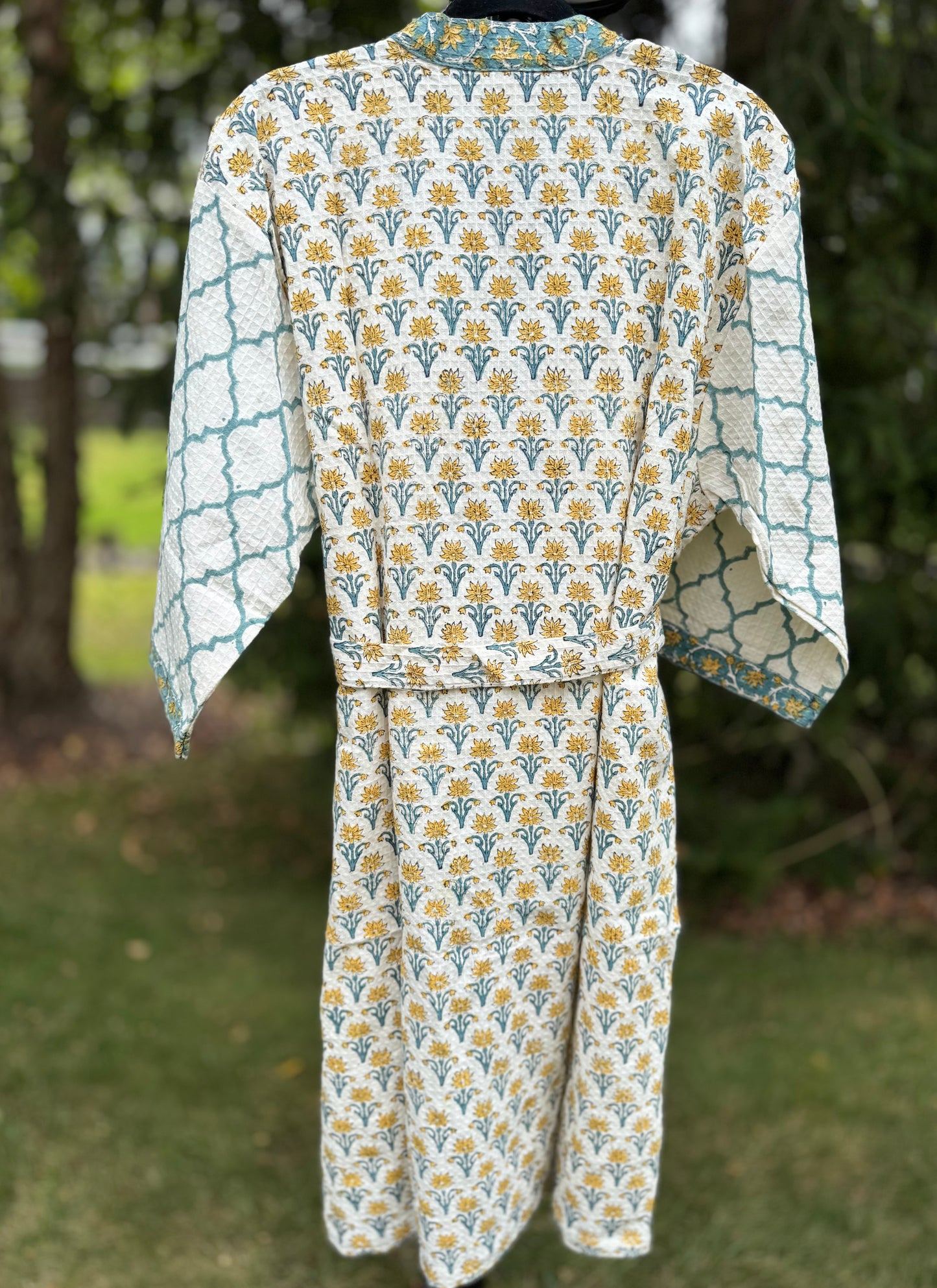 House of Mulmul - cotton bath robe. Floral and geometric patterned robe with yellow flowers and teal blue colors.