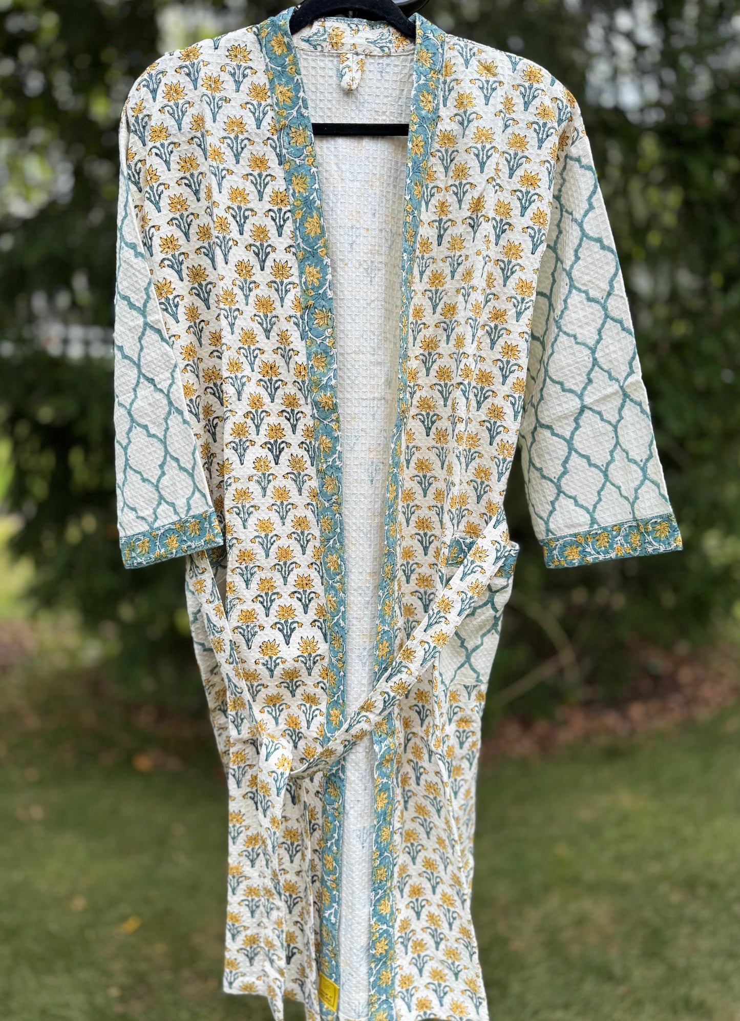 House of Mulmul - cotton bath robe. Floral and geometric patterned robe with yellow flowers and teal blue colors.