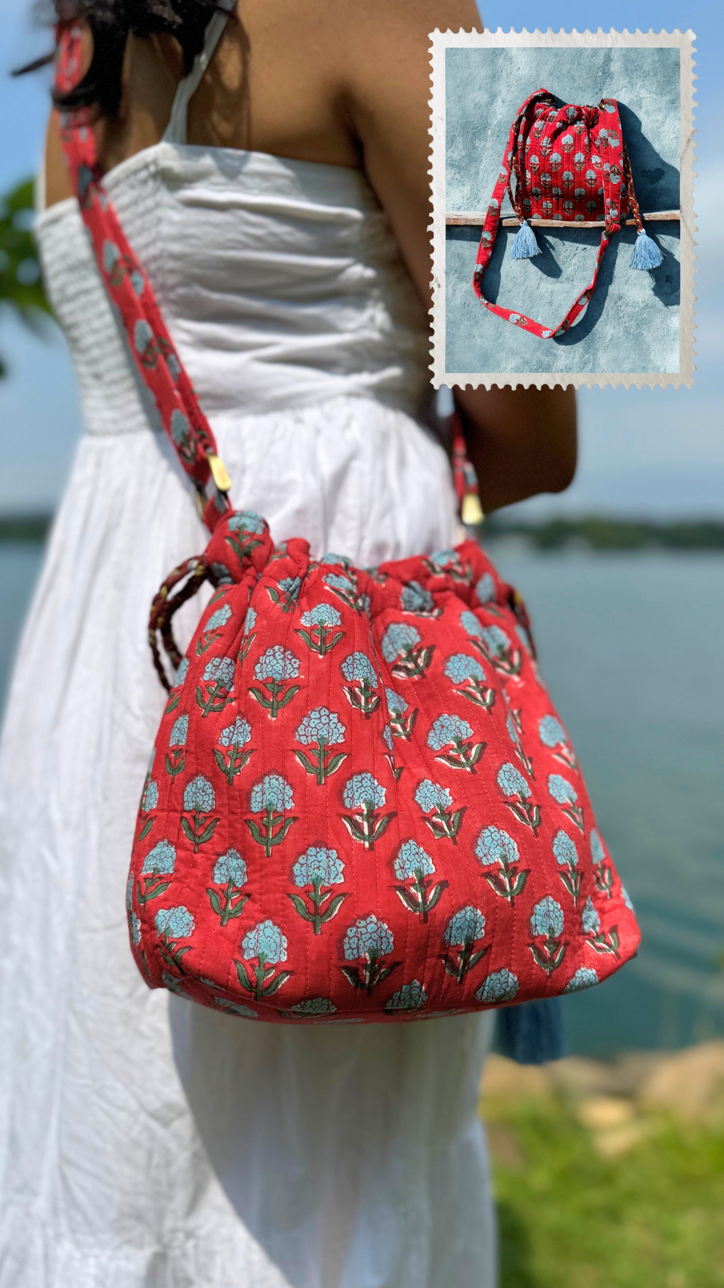 House of Mulmul - Garden Wayfarer Bucket Bag, Cotton bag, Crossbody sling bag. Red floral-patterned bag worn by a person with a scenic background