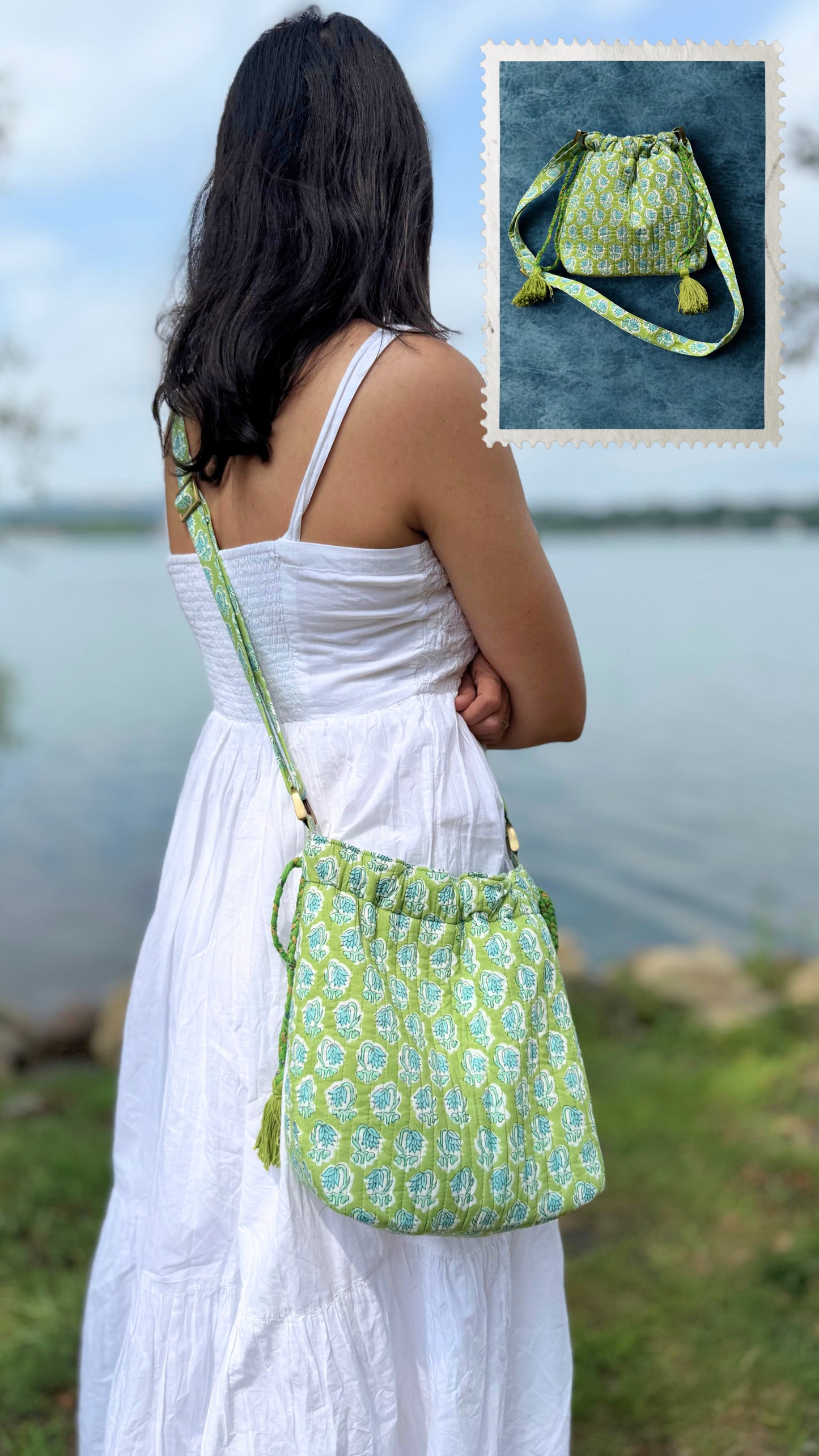 House of Mulmul - Garden Wayfarer Bucket Bag, Cotton bag, Crossbody sling bag. Woman in a white dress holding a green patterned handbag by a body of water.