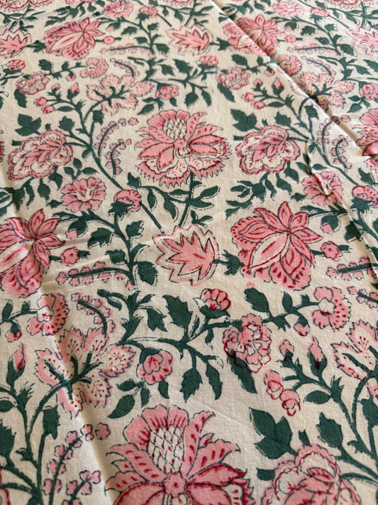 House of Mulmul - Cotton Table Cloth Round. Close-up of floral fabric with pink and green pattern