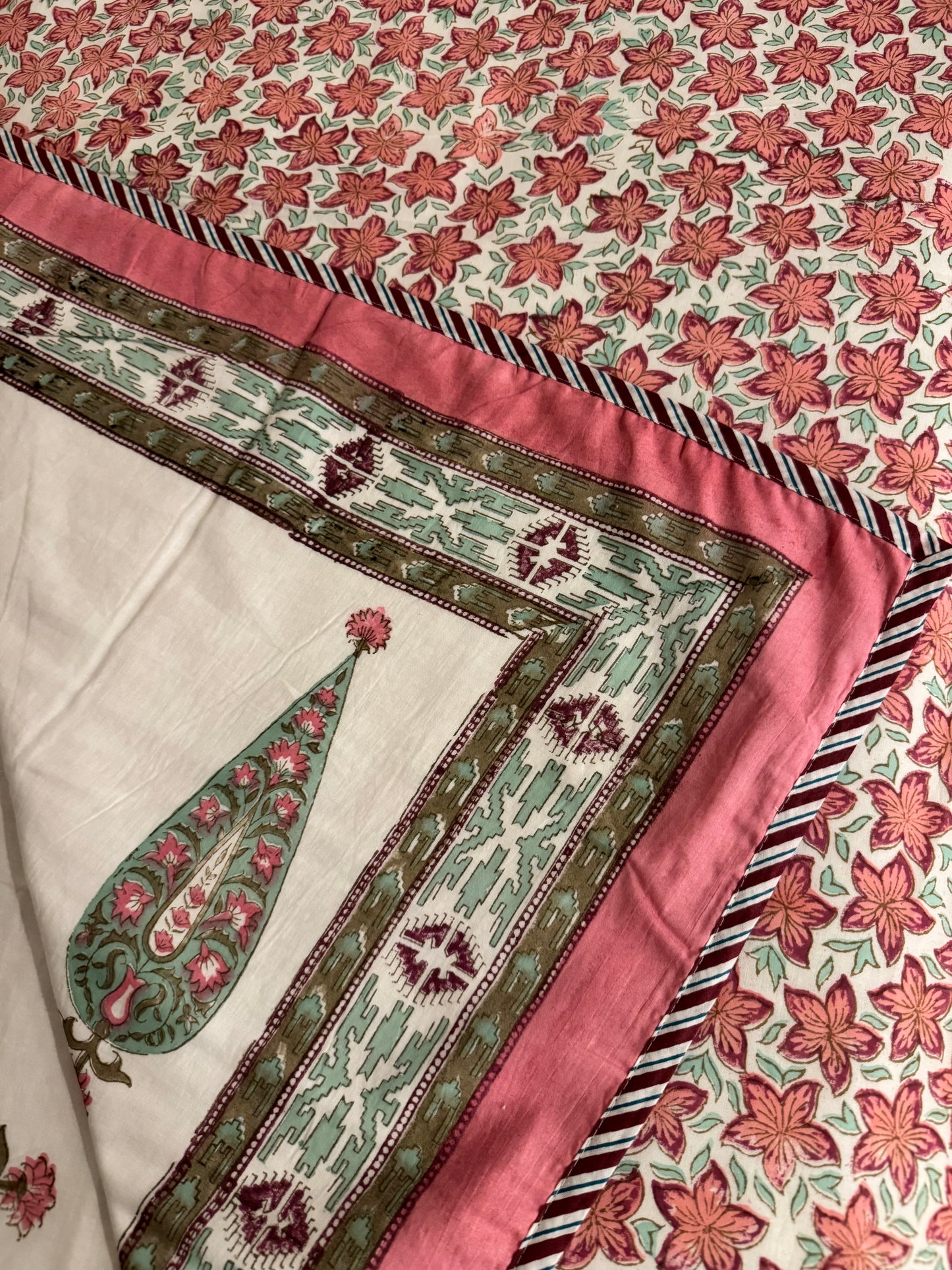 House of Mulmul - Coverlet Dohar, cotton blanket, muslin blanket, mulmul dohar. Close-up of a floral patterned fabric with a green leaf design on a white background.