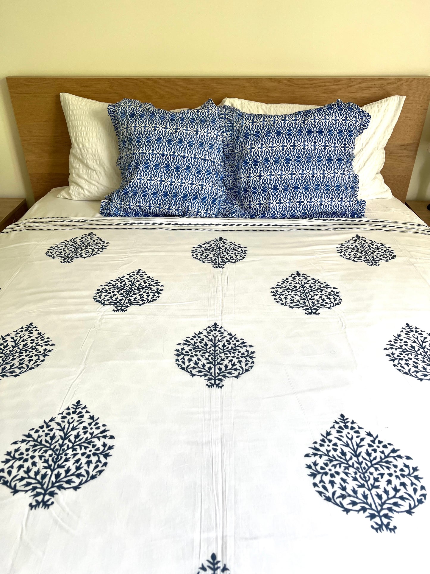 House of Mulmul - Cotton Coverlets (Dohar). Bed with white comforter and blue patterned pillows