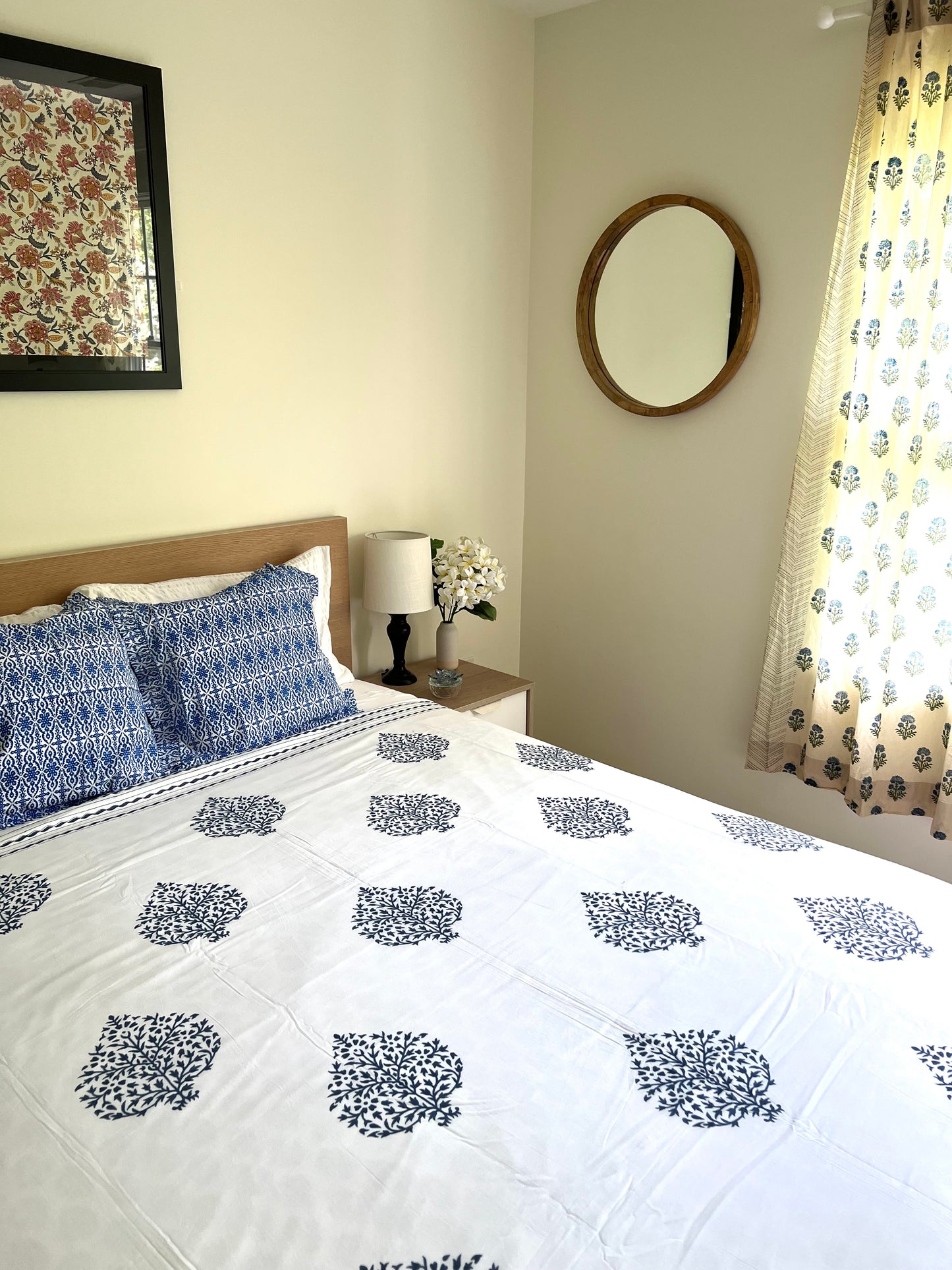 House of Mulmul - Cotton Coverlets (Dohar). Bedroom with floral bedspread, pillows, and decor elements.