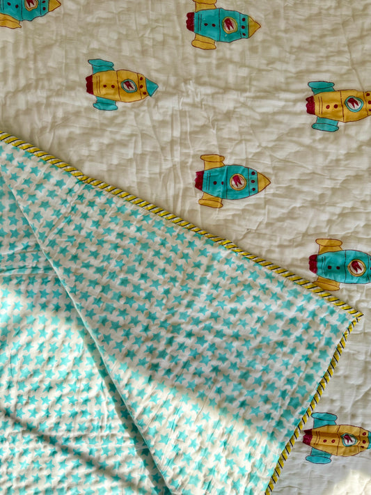 House of Mulmul - Blockprinted Kids Cotton Quilts with reversible design. Quilt with rocket ship pattern and stars with checkered border
