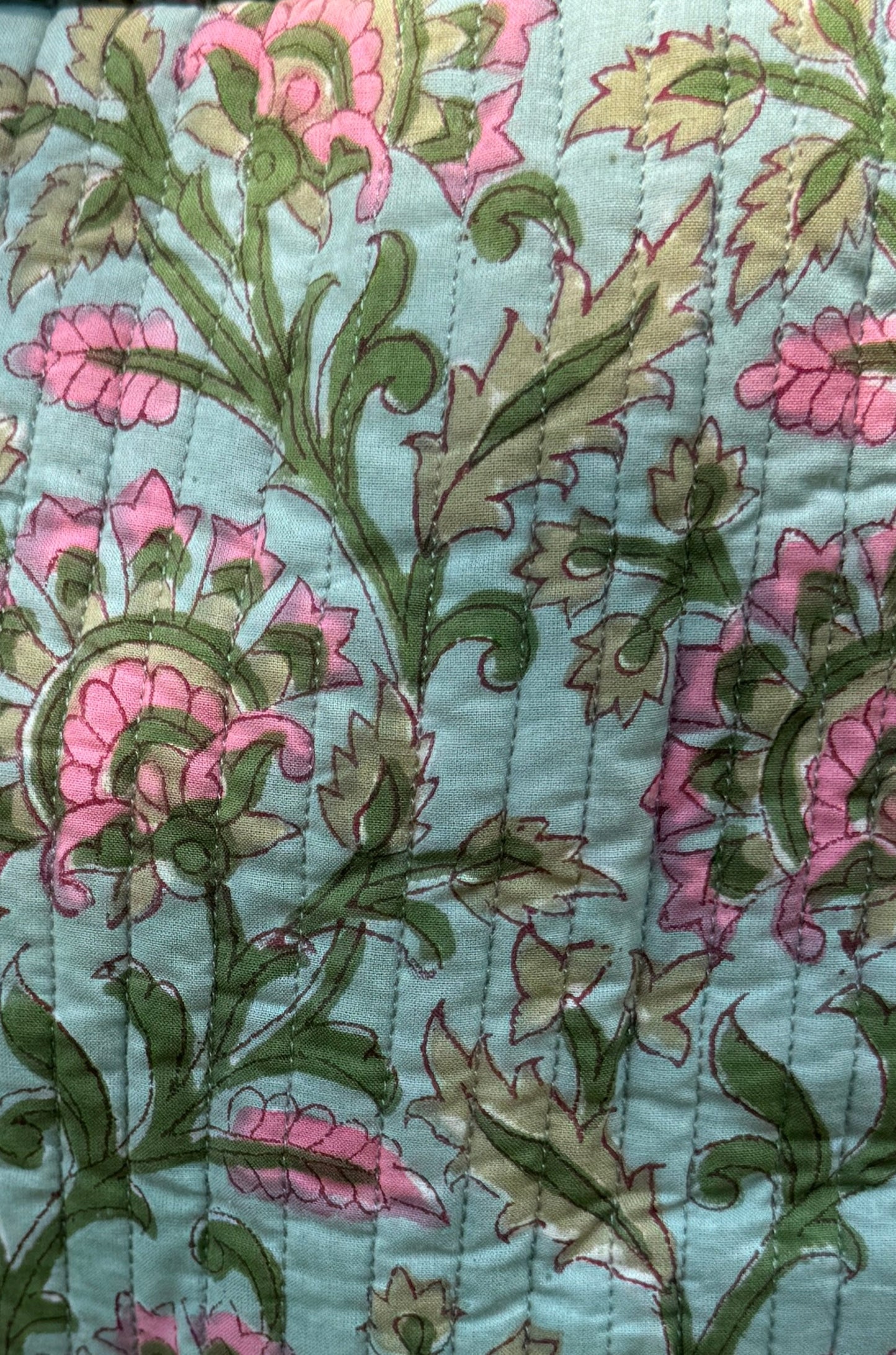House of Mulmul - Garden Wayfarer Bucket Bag, Cotton bag, Crossbody sling bag. Floral patterned fabric with pink and green flowers on a light blue background