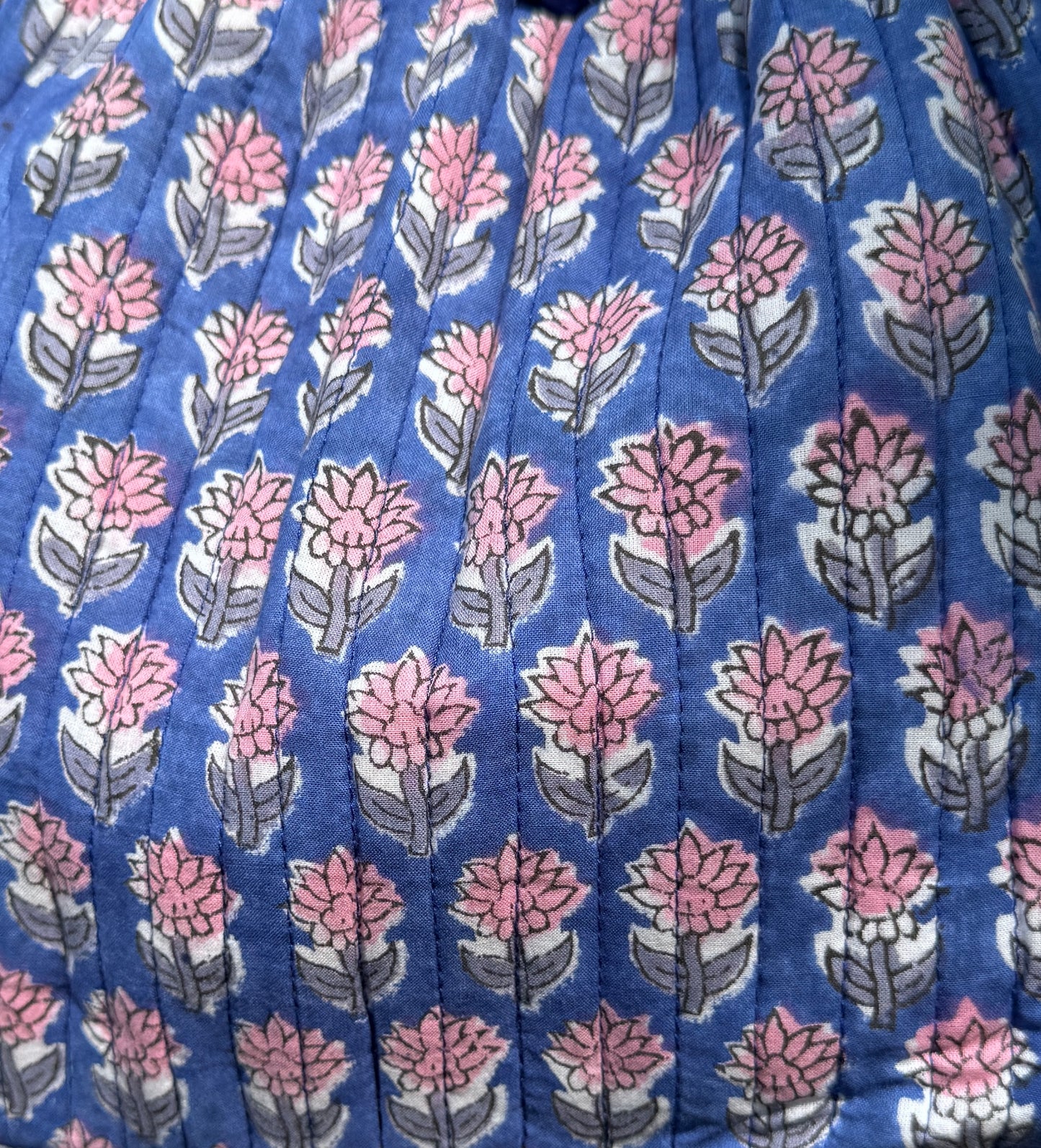 House of Mulmul - Garden Wayfarer Bucket Bag, Cotton bag, Crossbody sling bag. Floral patterned fabric with pink flowers on a blue background
