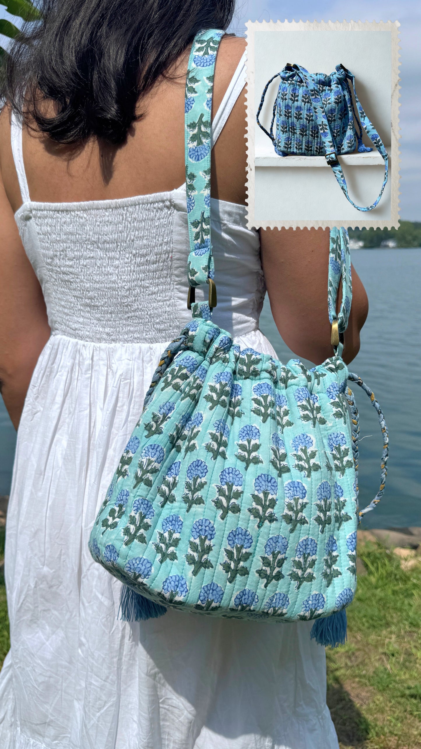 House of Mulmul - Garden Wayfarer Bucket Bag, Cotton bag, Crossbody sling bag. Woman holding a blue floral patterned bag by a lake