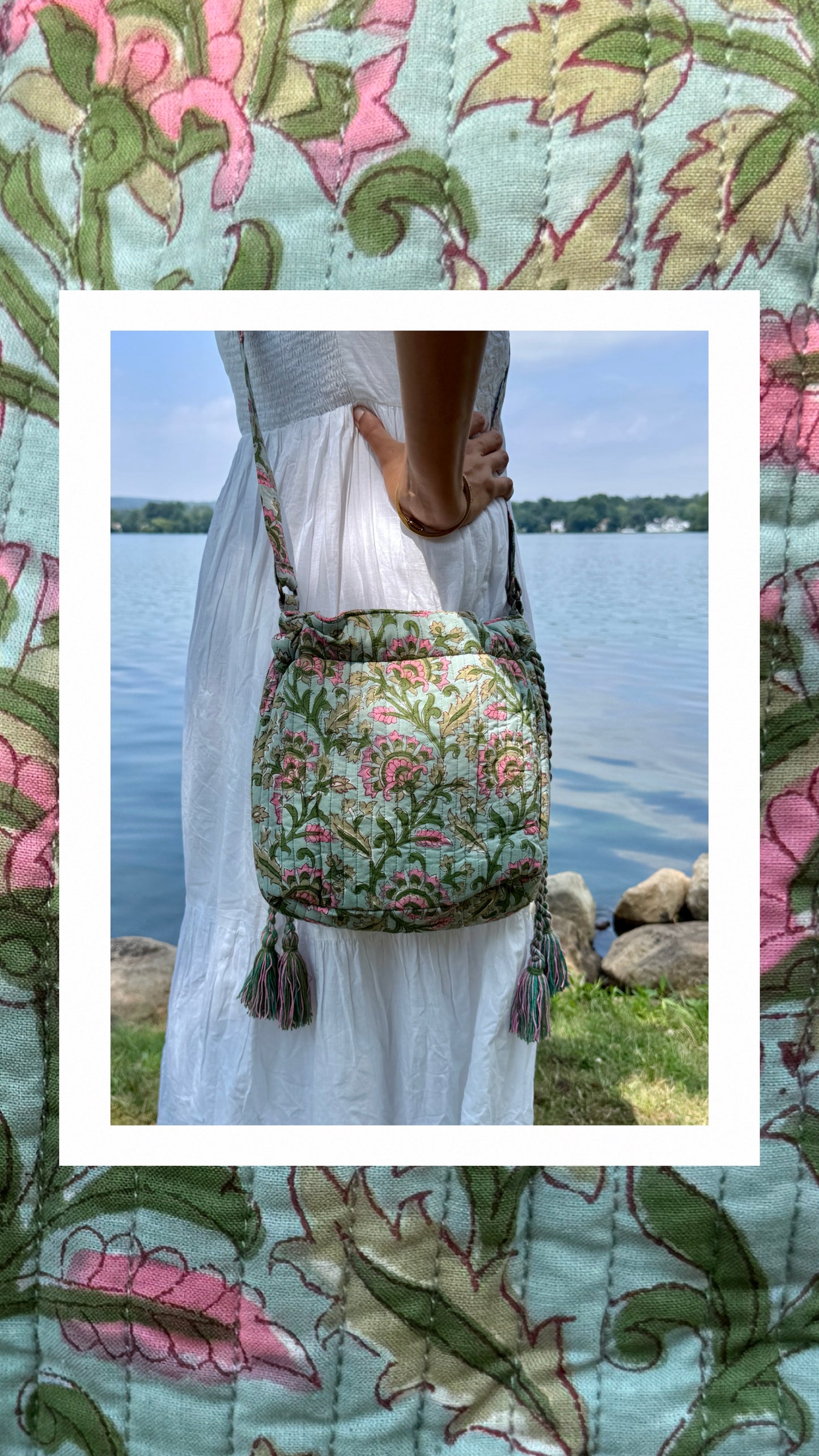 House of Mulmul - Garden Wayfarer Bucket Bag, Cotton bag, Crossbody sling bag. Person holding a floral-patterned bag by a body of water with a decorative border.