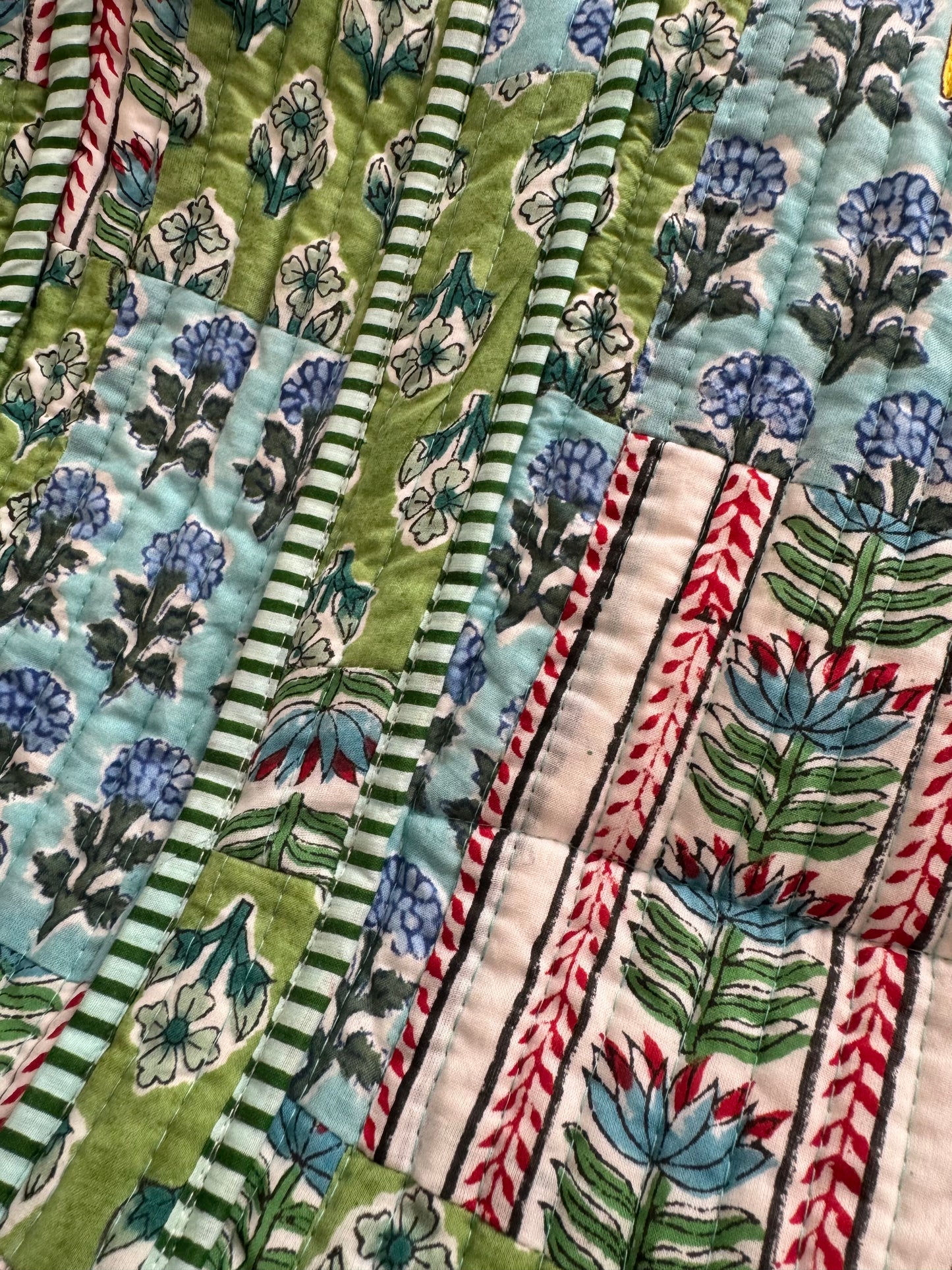House of Mulmul - Cotton Tote Bag. Close-up of a tote bag with floral and striped patterns in green, blue, and red.