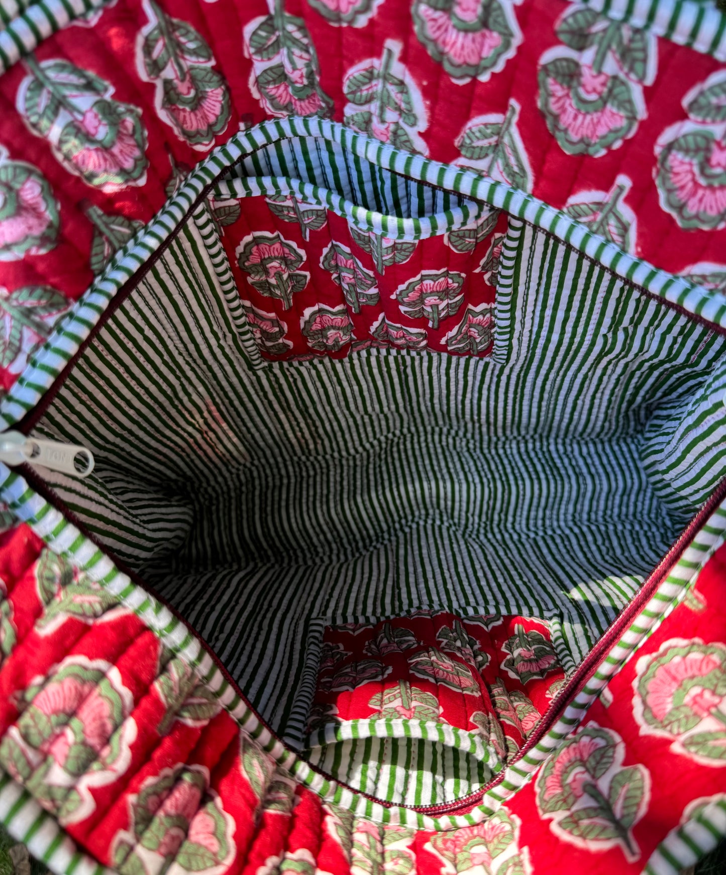 House of Mulmul - Cotton Tote Bag. Close-up of a fabric interior with red floral pattern and striped edges.