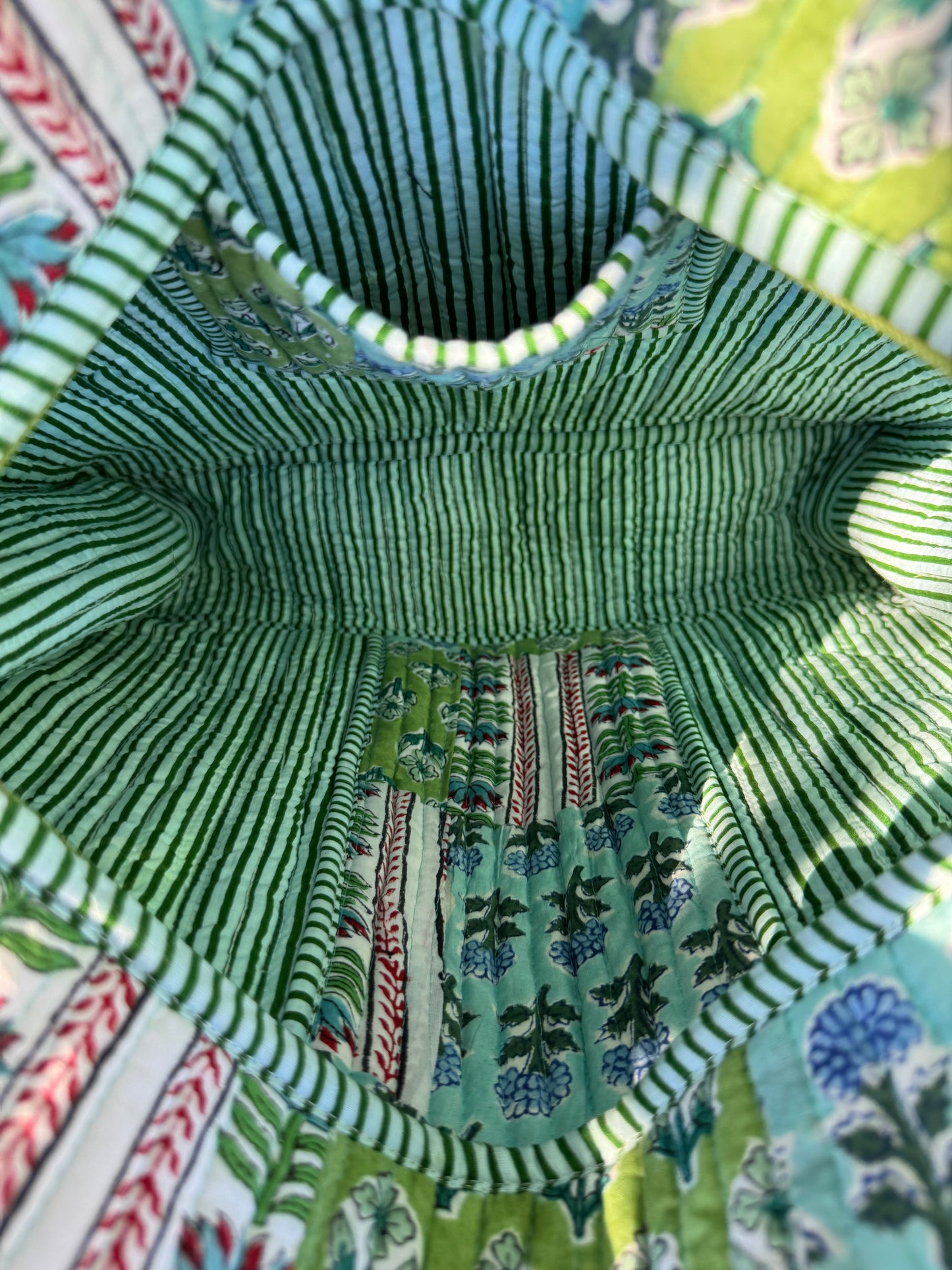 House of Mulmul - Cotton Tote Bag. Close-up of a fabric interior with green stripes and floral patterns.