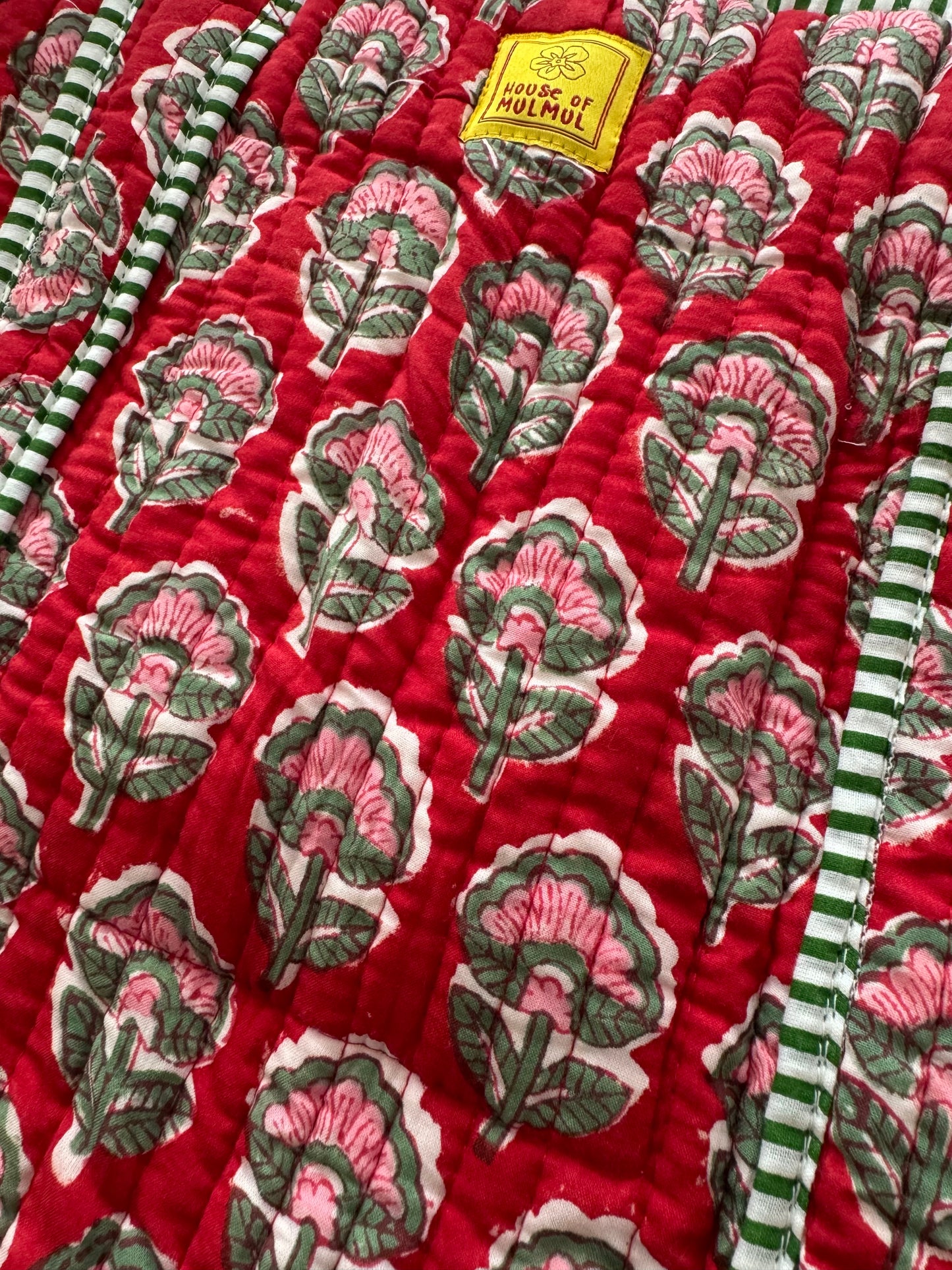 House of Mulmul - Cotton Tote Bag. Red fabric with floral patterns and green striped borders, featuring a label.