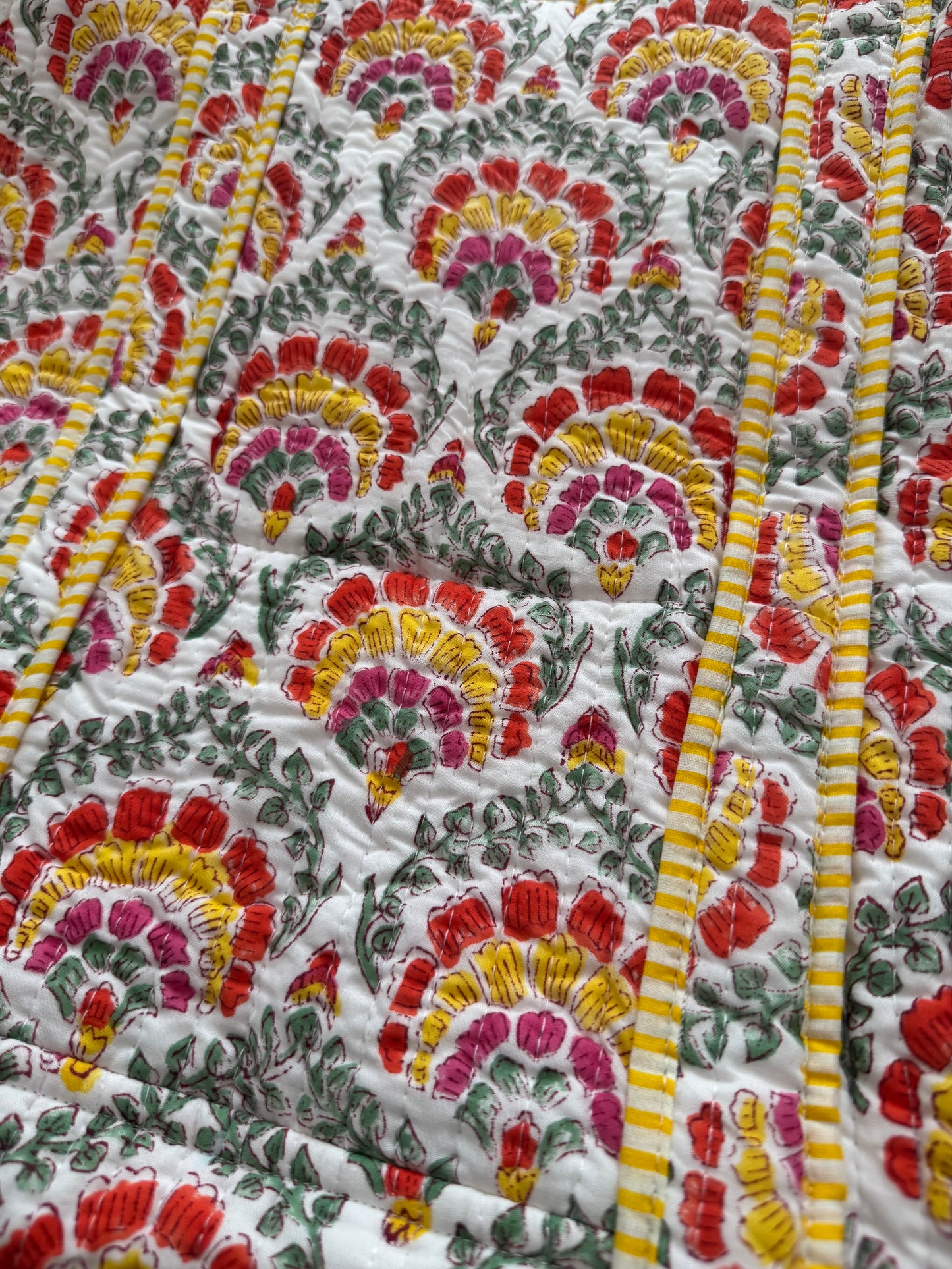House of Mulmul - Cotton Tote Bag. Close-up of a colorful floral patterned fabric with red, yellow, and green colors.