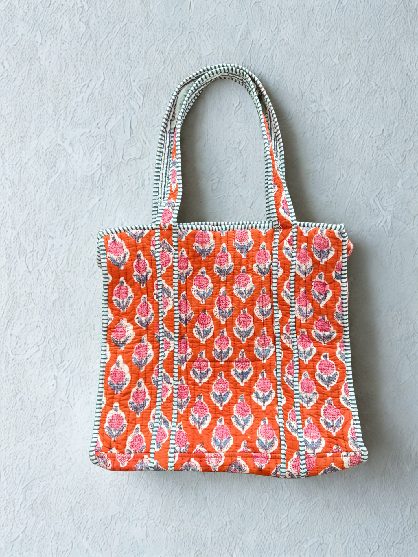 House of Mulmul - Cotton Tote Bag. Tote bag with Orange Pink floral pattern on a light gray background