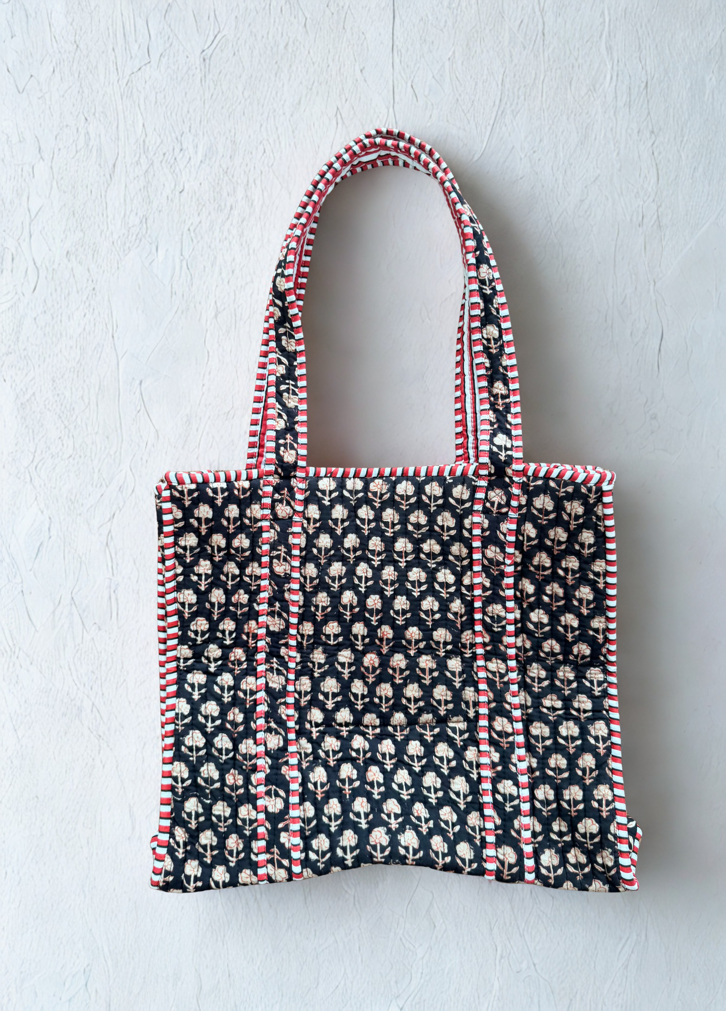 House of Mulmul - Cotton Tote Bag. Black Tote bag with pattern and red accents on a light gray background