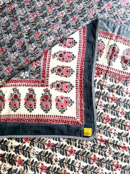 House of Mulmul - Handblock printed cotton summer quilt. Cotton coverlet. Cotton dohar. Muslin blanket. Indian summer quilt. Indian dohar. Floral patterned fabric with a visible brand label on a black background