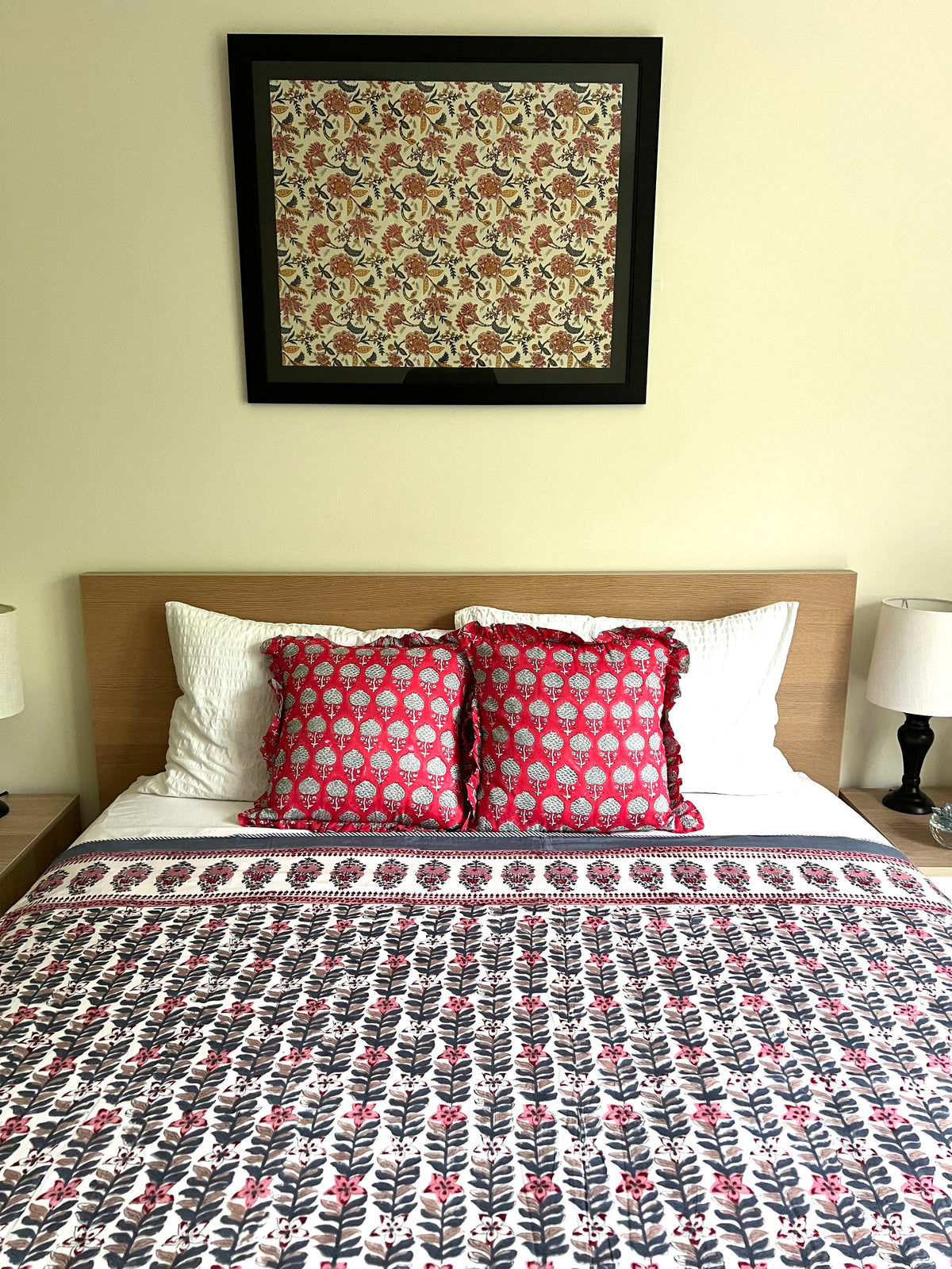 House of Mulmul - Handblock printed cotton summer quilt. Cotton coverlet. Cotton dohar. Muslin blanket. Indian summer quilt. Indian dohar. Bedroom with floral bedspread, pillows, and framed artwork on the wall.