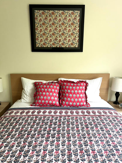 House of Mulmul - Handblock printed cotton summer quilt. Cotton coverlet. Cotton dohar. Muslin blanket. Indian summer quilt. Indian dohar. Bedroom with floral bedspread, pillows, and framed artwork on the wall.