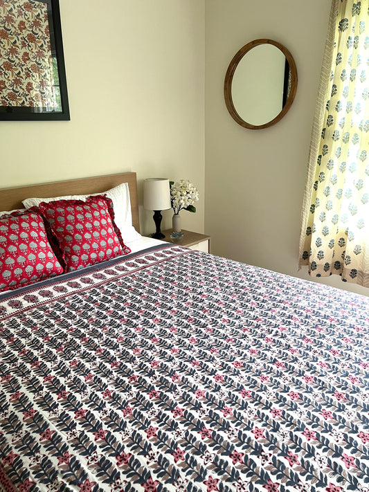 House of Mulmul - Handblock printed cotton summer quilt. Cotton coverlet. Cotton dohar. Muslin blanket. Indian summer quilt. Indian dohar. Bedroom with floral bedspread, pillows, and decor elements.