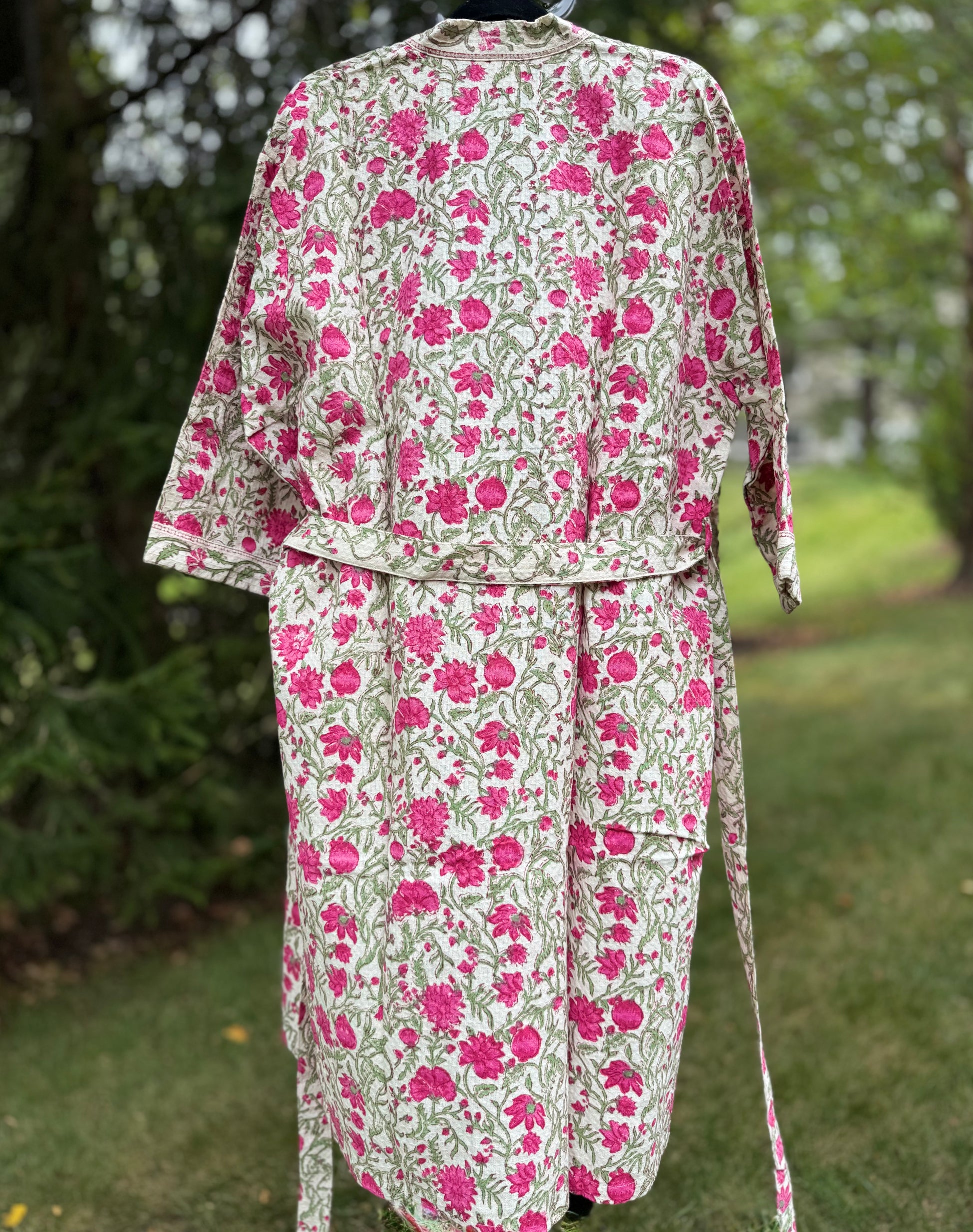 House of Mulmul - cotton bath robe. Floral patterned robe with pink flowers on a green background.