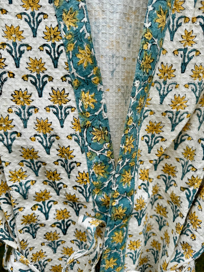 House of Mulmul - cotton bath robe. Close-up of floral patterned fabric with blue and yellow colors.