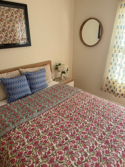 House of Mulmul - Blockprinted Cotton Quilt. Reversible Quilt. Bedroom with floral hand blockprinted bedspread cotton quilt, pillows, and decorative elements.