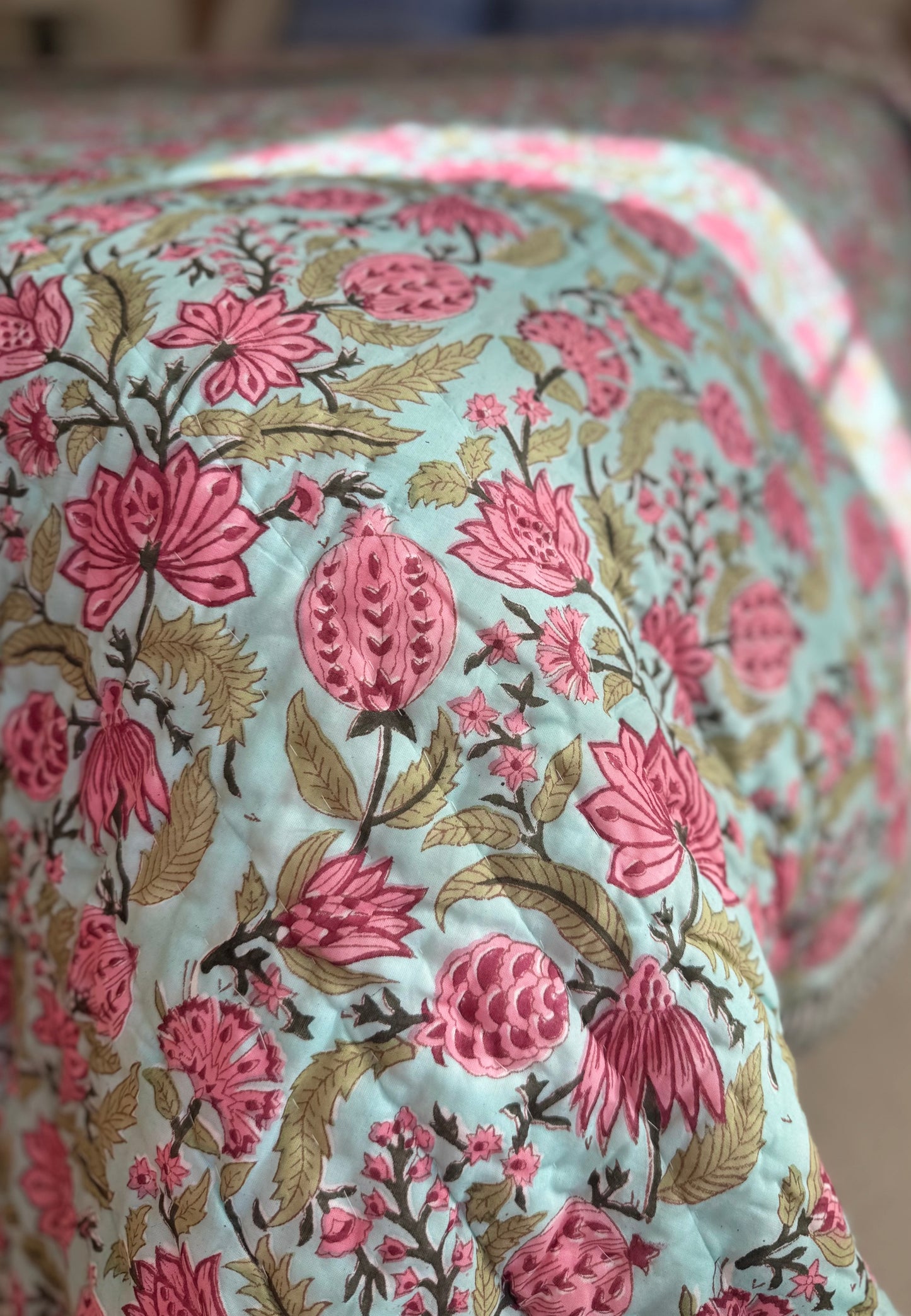 House of Mulmul - Blockprinted Cotton Quilt. Reversible Quilt. Bedroom with floral hand blockprinted bedspread cotton quilt, pillows, and decorative elements.