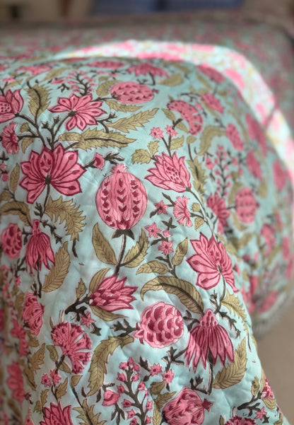 House of Mulmul - Blockprinted Cotton Quilt. Reversible Quilt. Bedroom with floral hand blockprinted bedspread cotton quilt, pillows, and decorative elements.