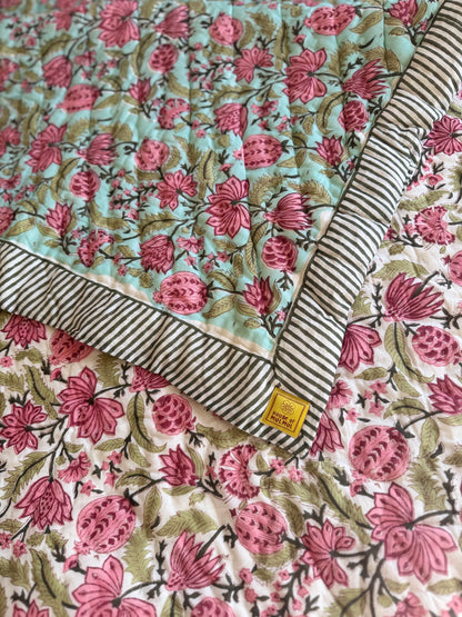 House of Mulmul - Blockprinted Cotton Quilt. Reversible Quilt. Bedroom with floral hand blockprinted bedspread cotton quilt, pillows, and decorative elements.