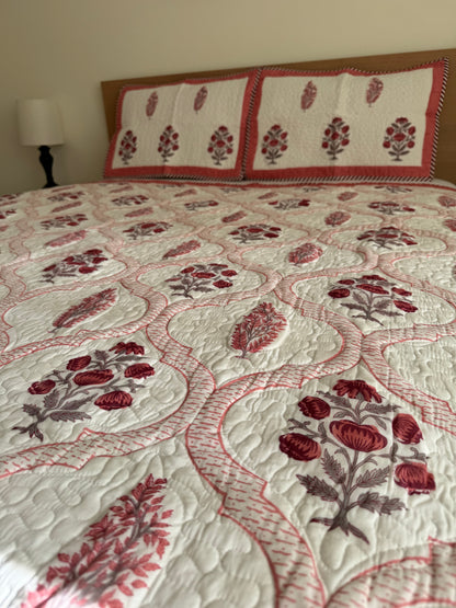 House of Mulmul - Blockprinted Cotton Bedcover Reversible Muslin. Bedcover with red floral pattern on a bed in a room setting