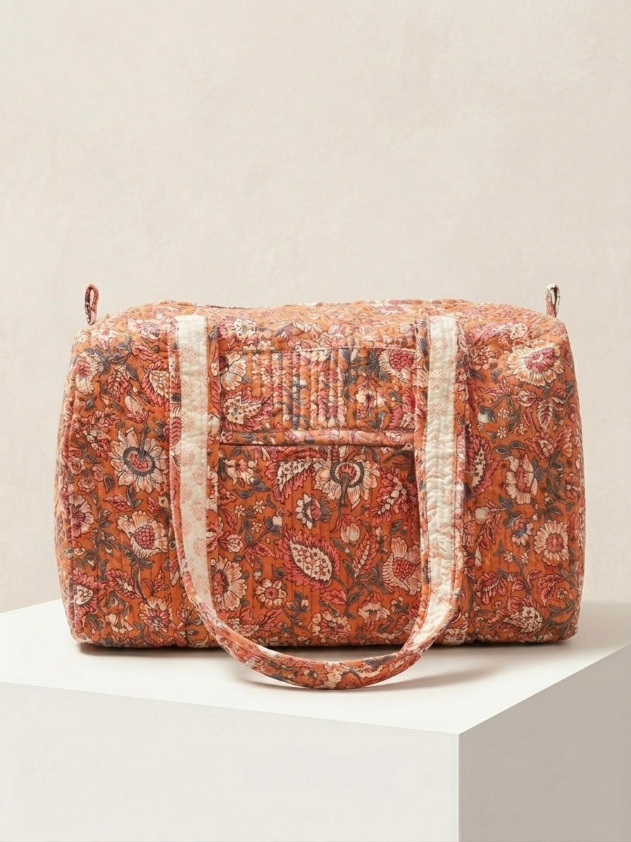 House of Mulmul - Blockprinted Cotton Duffle Bag Weekender Bag. Patterned duffel bag with white strap on a light beige background