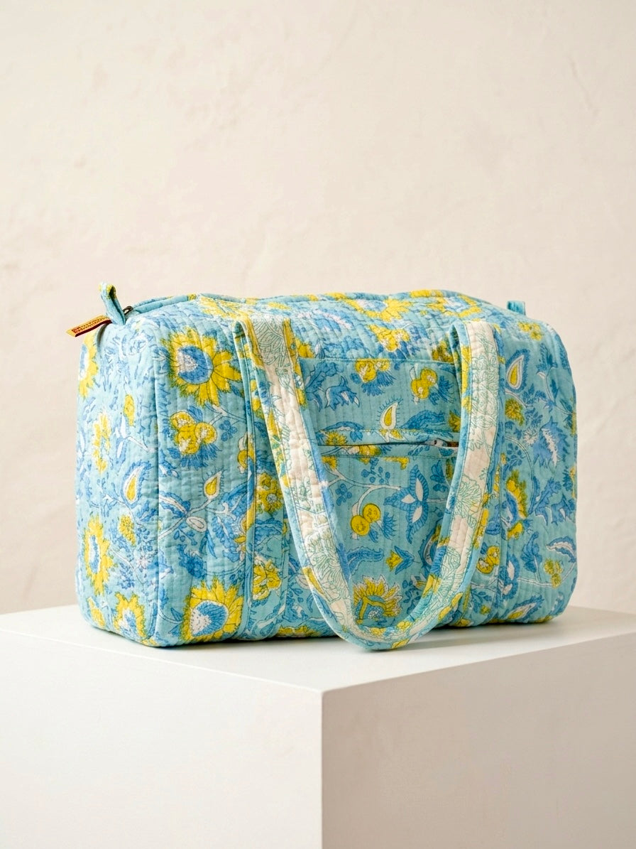 House of Mulmul - Blockprinted Cotton Duffle Bag Weekender Bag. Blue floral patterned bag on a light beige background