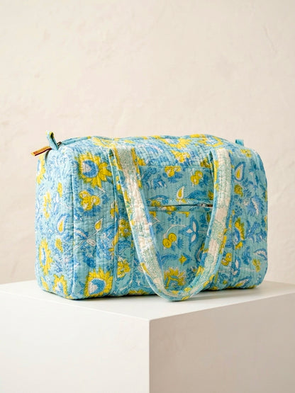 House of Mulmul - Blockprinted Cotton Duffle Bag Weekender Bag. Blue floral patterned bag on a light beige background