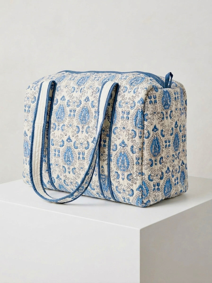 House of Mulmul - Blockprinted Cotton Duffle Bag Weekender Bag. Blue and white patterned bag on a white surface with a light gray background