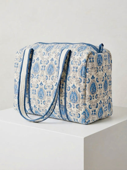 House of Mulmul - Blockprinted Cotton Duffle Bag Weekender Bag. Blue and white patterned bag on a white surface with a light gray background