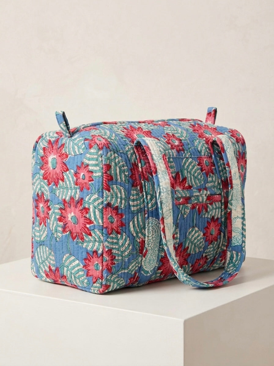 House of Mulmul - Blockprinted Cotton Duffle Bag Weekender Bag. Floral patterned bag on a white surface with a light beige background