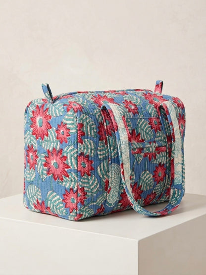 House of Mulmul - Blockprinted Cotton Duffle Bag Weekender Bag. Floral patterned bag on a white surface with a light beige background