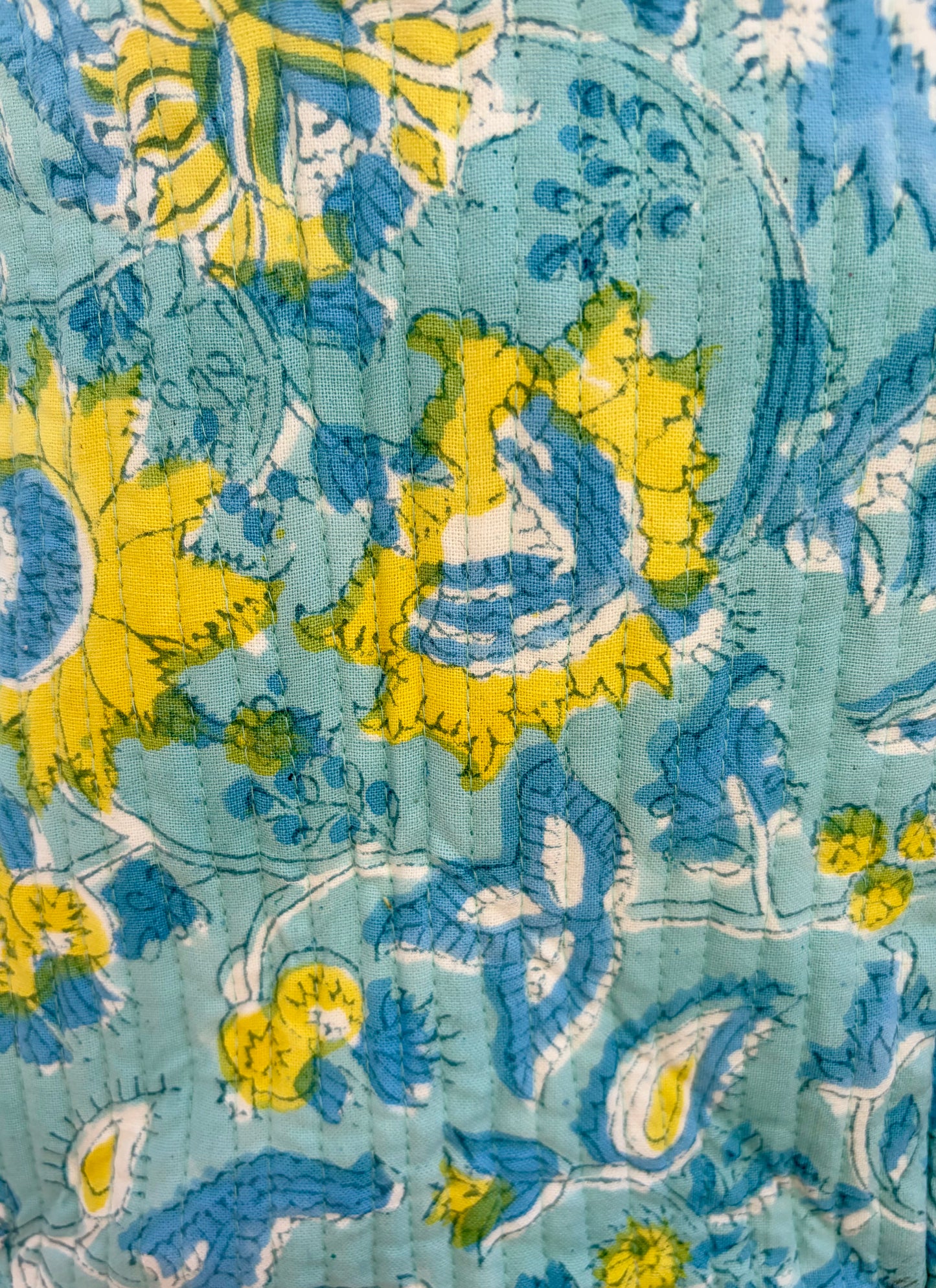House of Mulmul - Blockprinted Cotton Duffle Bag Weekender Bag. Close-up of a fabric with blue and yellow floral pattern