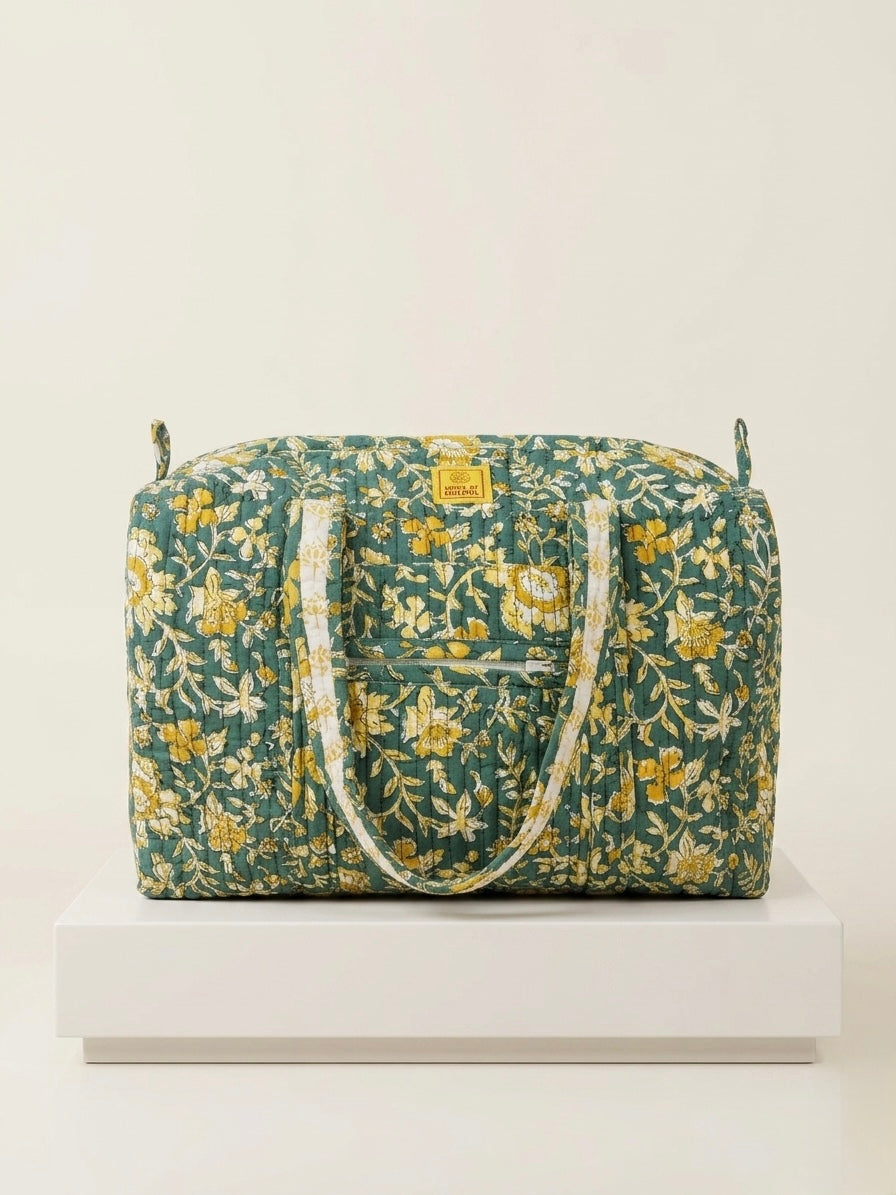 House of Mulmul - Blockprinted Cotton Duffle Bag Weekender Bag. Floral patterned bag on a white surface with a light beige background