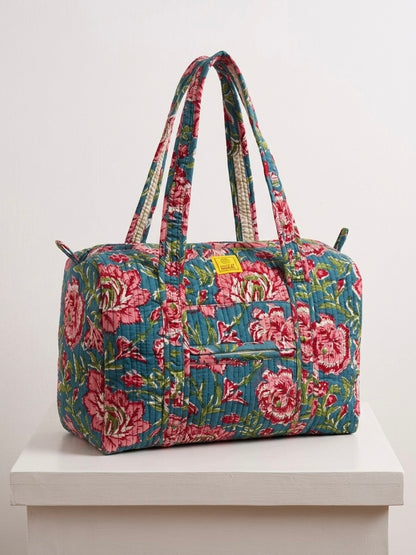 House of Mulmul - Blockprinted Cotton Duffle Bag Weekender Bag. Floral patterned bag on a white surface with a light gray background