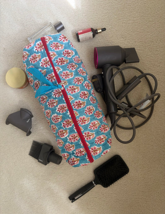 House of Mulmul - Blockprinted Cotton Hair Tool Bag. Dyson hair dryer and straightener kit with accessories and a floral-patterned bag on a beige surface