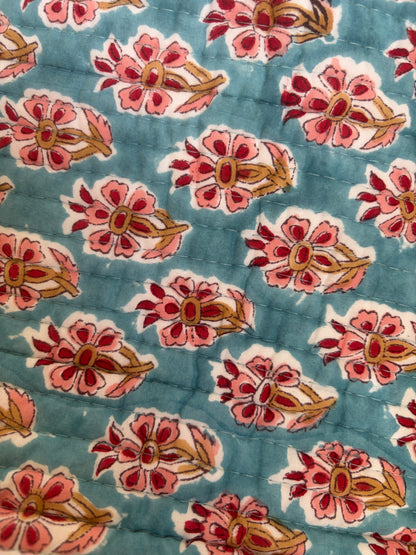 House of Mulmul - Blockprinted Cotton Hair Tool Bag. Close-up of floral patterned hair tool bag with pink and red flowers on a blue background