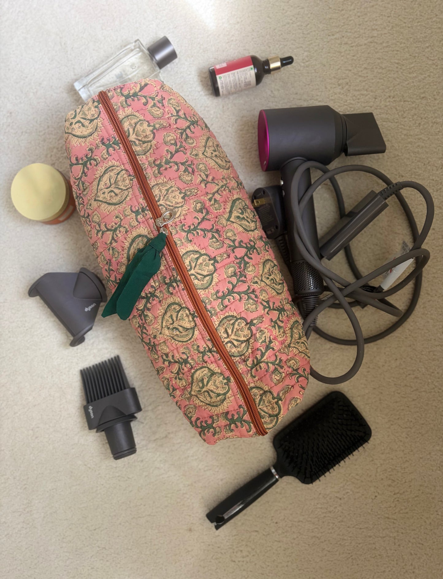 House of Mulmul - Blockprinted Cotton Hair Tool Bag. Dyson hair dryer and straightener kit including a floral-patterned bag, hair dryer, and brush on a beige surface.