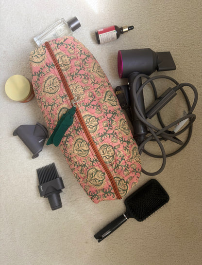 House of Mulmul - Blockprinted Cotton Hair Tool Bag. Dyson hair dryer and straightener kit including a floral-patterned bag, hair dryer, and brush on a beige surface.