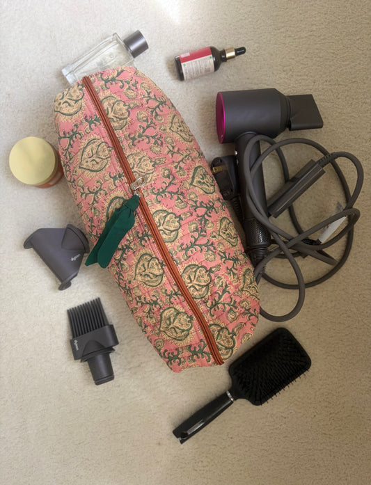 House of Mulmul - Blockprinted Cotton Hair Tool Bag. Dyson hair dryer and straightener kit including a floral-patterned bag, hair dryer, and brush on a beige surface.